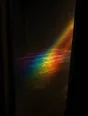 Refracted-light photograph: an empty stage seen from the wings, a beam of spectral light falling on the bare boards.