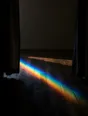 Refracted-light photograph: curtains pulled fully open at dawn, a band of refracted light across the wooden floor.