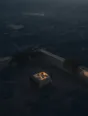Dawn aerial photograph: a rooftop breakfast table set for two, the town below still grey and asleep.