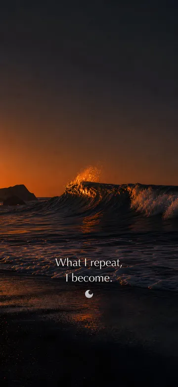 Self-talk affirmations wallpaper: dark elemental photograph of ember waves breaking on black sand at dusk, the next swell crest dissolving into small glowing marks, with the affirmation 'What I repeat, I become.' in serif type.