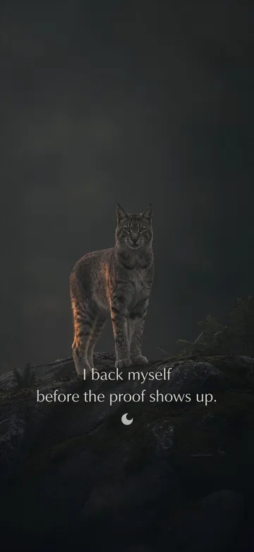 Confidence affirmations wallpaper: dark green cinematic photograph of a lynx standing calm on a mossy granite outcrop among hazy pines, dawn gold on its flank, with the affirmation 'I back myself before the proof shows up.' in serif type.