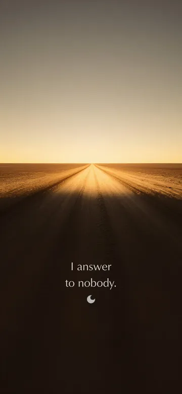 Struck-light photograph: a dirt road running clean to the horizon in low afternoon light, with the typeset line "I answer to nobody."