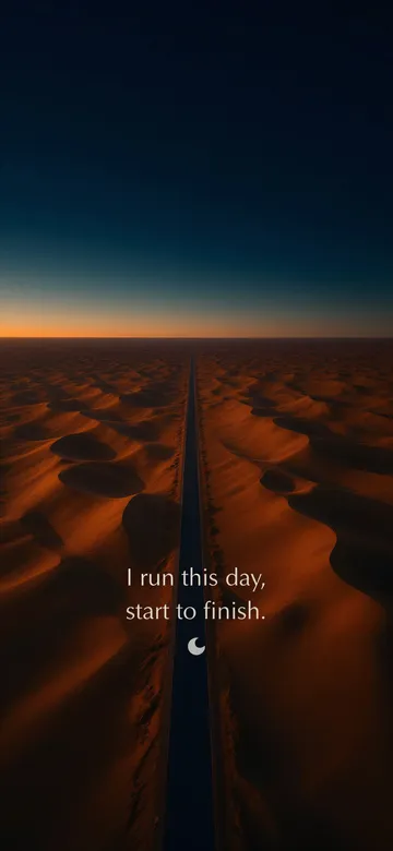 Morning affirmations wallpaper — dawn aerial photograph of one empty road running straight across a deep orange dune field toward the pre-dawn horizon, with the affirmation 'I run this day, start to finish.' in serif type.