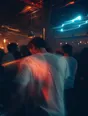 Motion photograph: a man dancing at the back of a crowded room at night, the room's lights swinging around him
