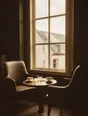 Struck-light photograph: two chairs drawn close across a low table at a tall window on an overcast afternoon, both cups used and pushed aside