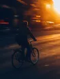 Motion photograph: a man cycling to work through a city at dawn, panned so he holds his shape while the whole street pulls sideways