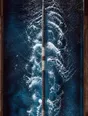 Motion photograph: one lane of an outdoor pool seen directly overhead in hard daylight, the churn a swimmer has just torn through it