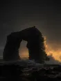 Dark elemental photograph: a half carved black sea arch at golden hour, its unfinished side dissolving into warm glowing marks.