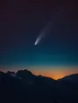 Film photograph: a comet with a fine bright tail hanging in a star-dense indigo sky over a dark mountain ridgeline.