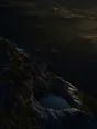 Dawn aerial photograph: a clear spring filling a carved stone basin set into a mossy hillside.