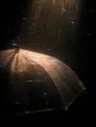 Prism-light photograph: An umbrella held up against driving rain with the sun breaking through the shower, the drops combing the light.