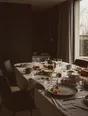 Struck-light photograph: a family breakfast table on an overcast morning, the meal half eaten and every chair pushed back