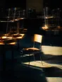 Prism-light photograph: A cafe at opening with the chairs still stacked on every table except one taken down and set straight.