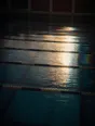 Prism-light photograph: A swimming pool at first light with the lane ropes laid out, sun combing the ripple on the surface.