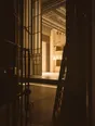Struck-light photograph: a brightly lit stage seen from the dark of the wings, the ropework standing in flat silhouette