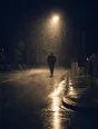 Motion photograph: a man walking through heavy rain at night on an ordinary street, lit hard from behind by one streetlamp