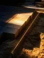 Prism-light photograph: Newly laid paving snapped to a taut string line, hard sun across the sand and the string.