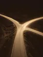 Struck-light photograph: a road at night splitting three ways with all three routes lit and open