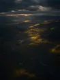 Dawn aerial photograph: broken morning clouds throwing moving patches of light and shadow across moorland.
