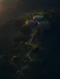 Dawn aerial photograph: stone cisterns brimming on a hillside, channels running down to green garden plots.