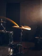 Motion photograph: a drum kit mid-strike in a dim rehearsal room, one stick swinging through its full arc and the cymbal still ringing