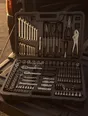 Struck-light photograph: a well-kept toolkit lying open on a tailgate at dusk with every tool in its place