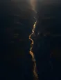 Dawn aerial photograph: first light reaching the golden thread of river at the bottom of a deep gorge.
