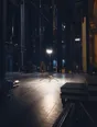 Dark cinematic photograph: A stage being lit for a set, one work light burning alone at centre.