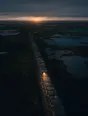 Dawn aerial photograph: a long drystone wall with a single stone-sized gap, the low sun shining through it.