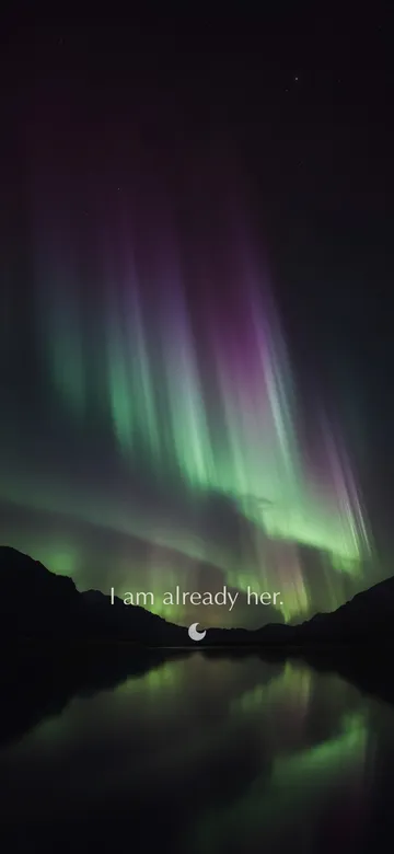 Affirmations for women wallpaper: night photograph of a green and violet aurora pouring down the sky over a dark still lake between black ridgelines, with the affirmation 'I am already her.' in serif type.